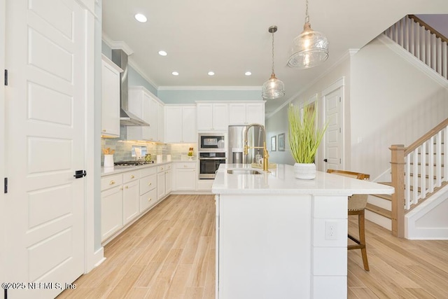kitchen with light wood-type flooring, light countertops, a sink, and stainless steel appliances