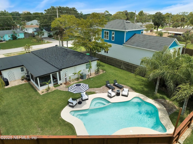 view of swimming pool with a fenced backyard, a lawn, central AC, and a patio