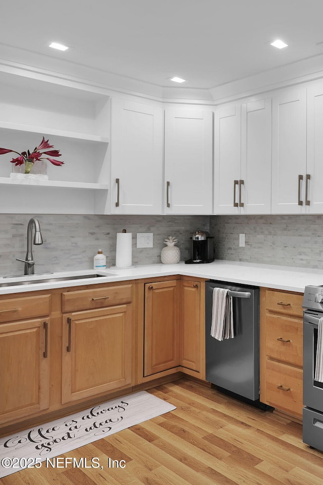 kitchen featuring a sink, open shelves, stainless steel appliances, light wood-style floors, and light countertops