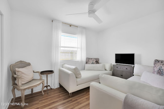 living area featuring a ceiling fan and wood finished floors