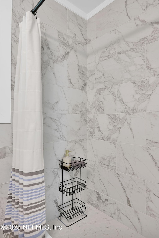 interior details featuring crown molding and a shower with curtain