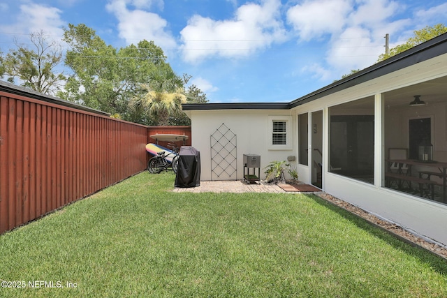 view of yard with a fenced backyard and a sunroom