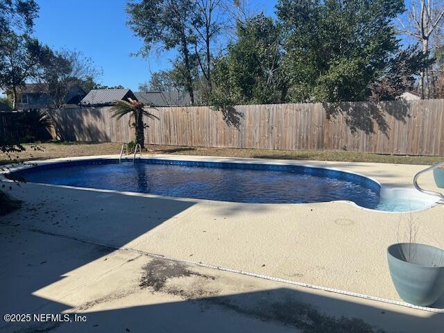 view of pool featuring a patio, a fenced backyard, and a fenced in pool