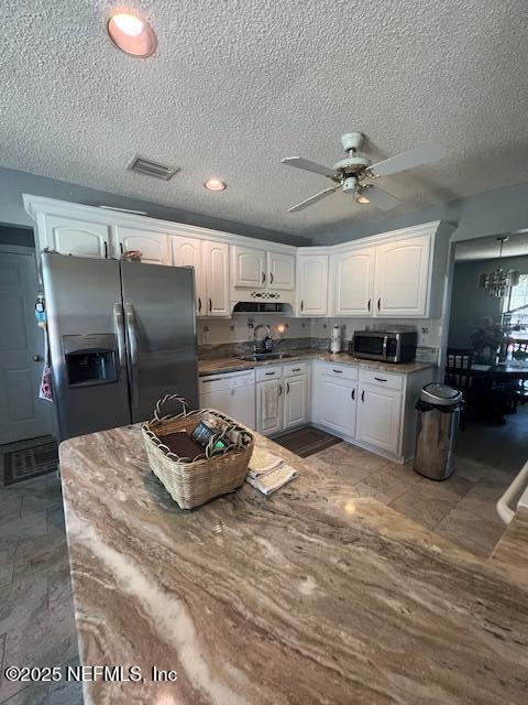 kitchen featuring white cabinets, ceiling fan, stainless steel appliances, and a sink