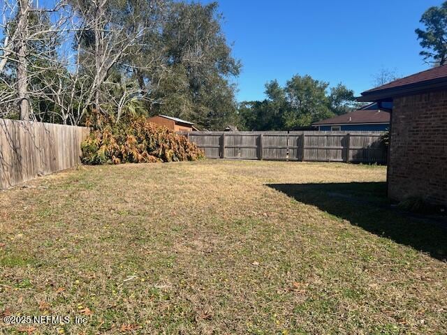 view of yard with a fenced backyard