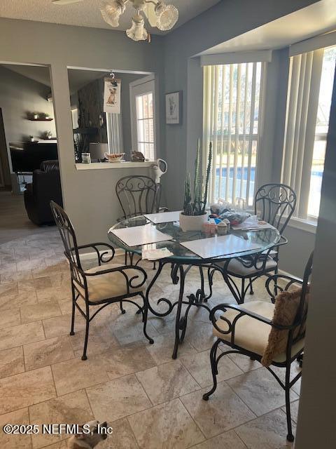 dining area featuring a textured ceiling