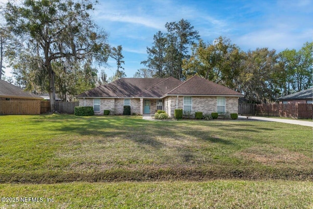 single story home with fence private yard and a front lawn