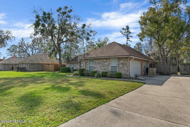 view of front of home featuring driveway, an attached garage, fence, a front yard, and brick siding