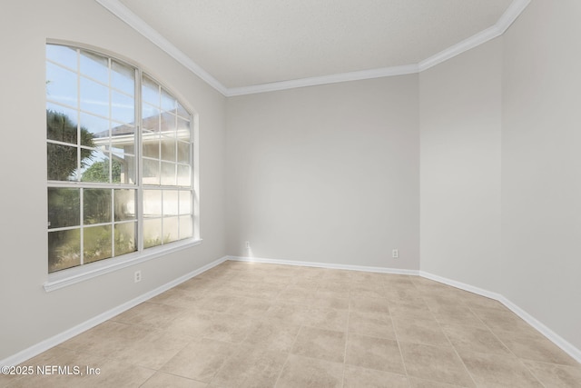 empty room with ornamental molding and baseboards