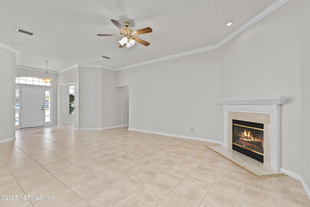 unfurnished living room with light tile patterned floors, a textured ceiling, a fireplace, baseboards, and ornamental molding