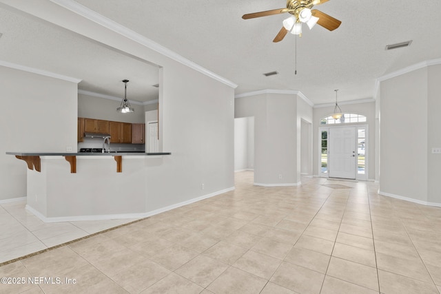 unfurnished living room featuring light tile patterned floors, baseboards, visible vents, and a textured ceiling