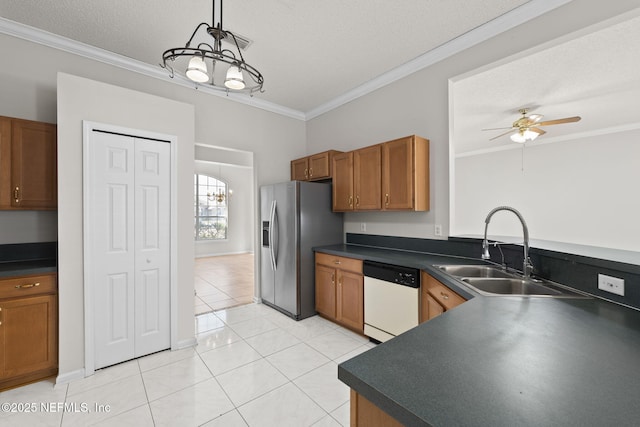 kitchen featuring dark countertops, stainless steel refrigerator with ice dispenser, white dishwasher, and a sink