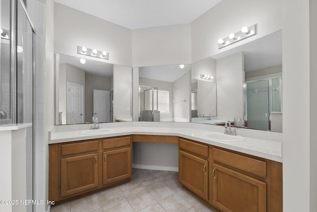 full bathroom with a shower stall, vanity, and tile patterned floors