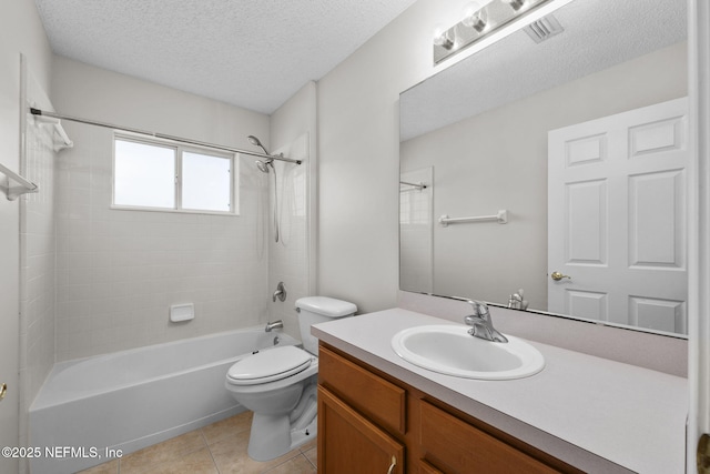 bathroom featuring a textured ceiling, bathtub / shower combination, toilet, vanity, and tile patterned floors