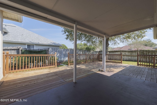 wooden terrace featuring a fenced backyard