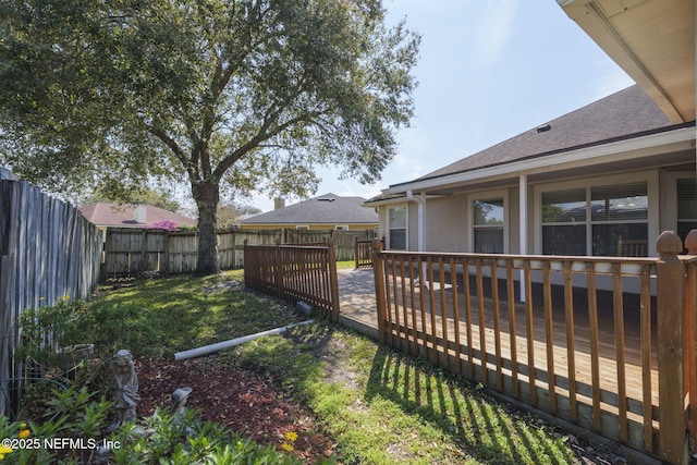 view of yard with a fenced backyard and a wooden deck