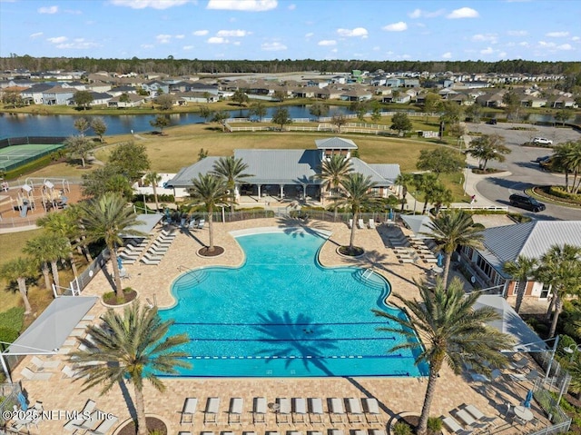 community pool featuring a residential view, a patio area, and a water view