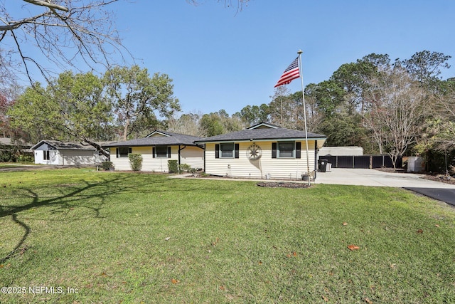 view of front of home with driveway and a front lawn