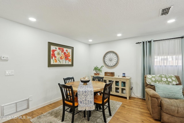 dining area with recessed lighting, visible vents, and light wood finished floors