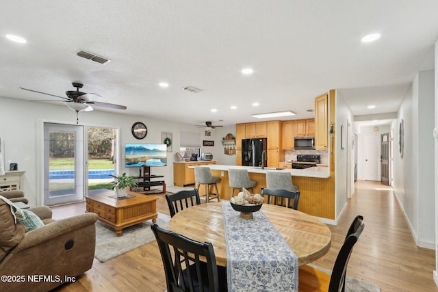 dining area with recessed lighting, visible vents, ceiling fan, and light wood-style flooring