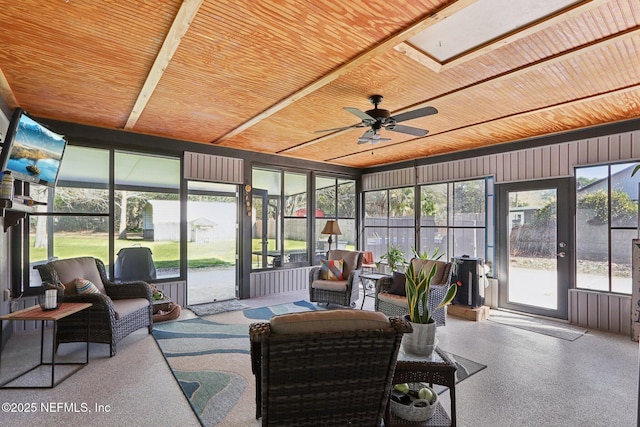 sunroom featuring wood ceiling and ceiling fan