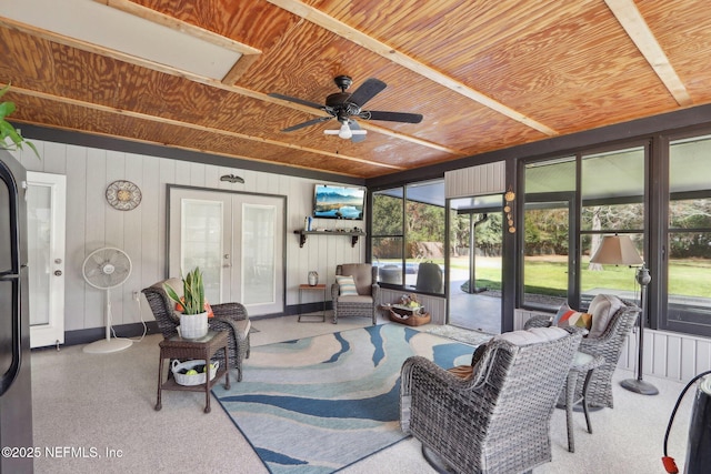 sunroom / solarium featuring a ceiling fan, wood ceiling, and french doors