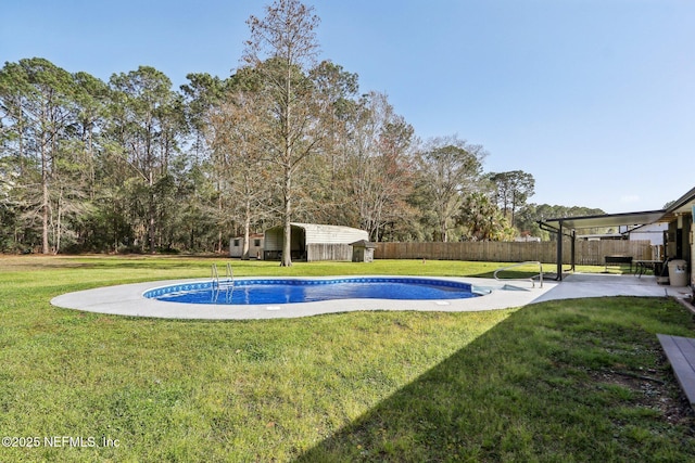 view of swimming pool with a fenced in pool, a patio area, and a lawn