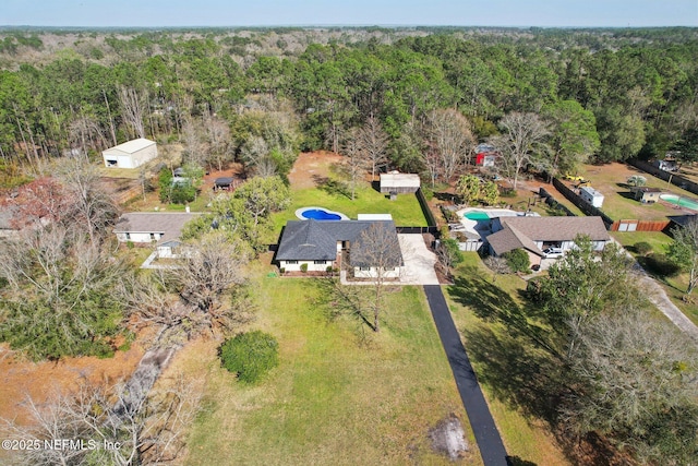 drone / aerial view featuring a wooded view