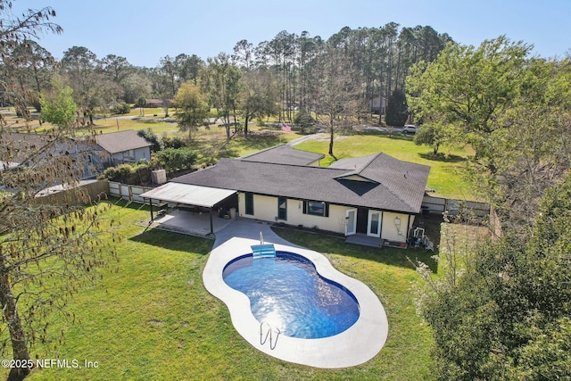 outdoor pool featuring a patio area and a yard