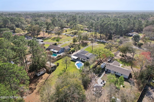 bird's eye view featuring a wooded view