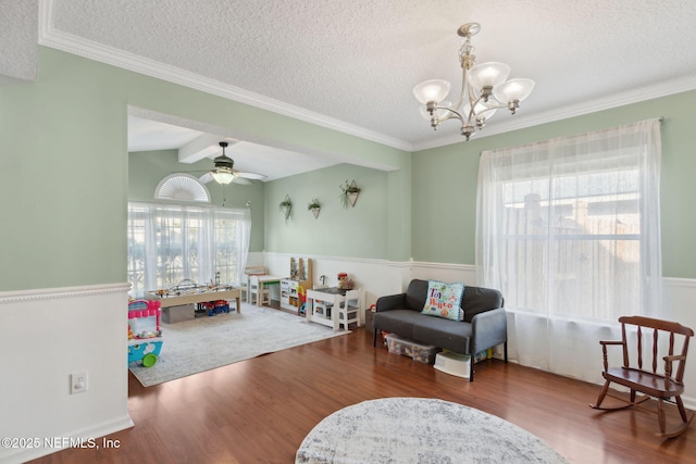 recreation room with a textured ceiling, ceiling fan with notable chandelier, wood finished floors, and vaulted ceiling with beams