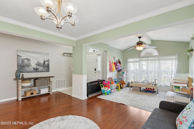 living area featuring vaulted ceiling with beams, visible vents, a textured ceiling, wood finished floors, and ceiling fan with notable chandelier