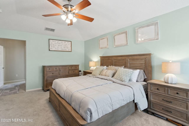 bedroom featuring baseboards, visible vents, light colored carpet, ceiling fan, and vaulted ceiling