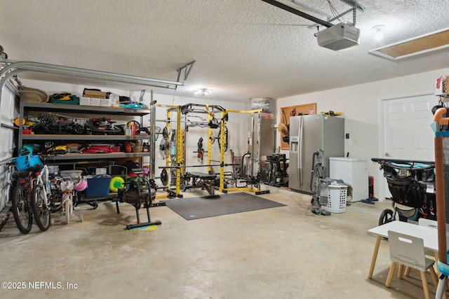 garage featuring refrigerator, stainless steel refrigerator with ice dispenser, and a garage door opener