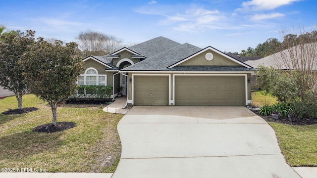 view of front of property with a shingled roof, concrete driveway, an attached garage, a front lawn, and stucco siding