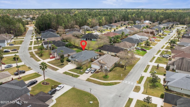 drone / aerial view with a forest view and a residential view