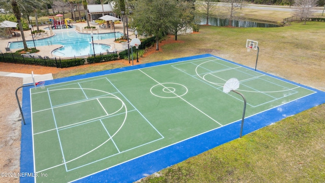 view of sport court with community basketball court, fence, and a lawn