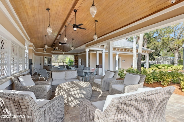 view of patio featuring outdoor dining area, a ceiling fan, and an outdoor living space