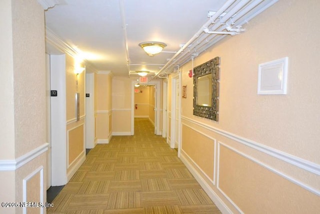 hall with a wainscoted wall and a decorative wall