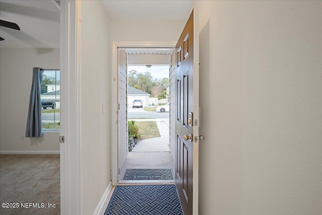 doorway with carpet and baseboards