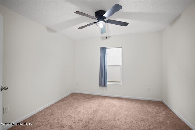 unfurnished room with a textured ceiling, carpet, a ceiling fan, and baseboards