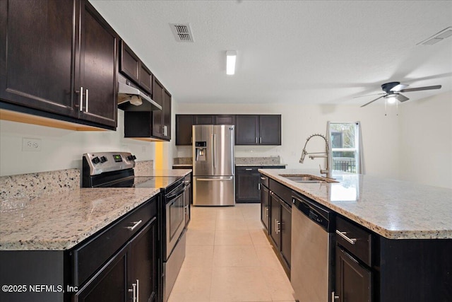 kitchen featuring under cabinet range hood, visible vents, stainless steel appliances, and a sink