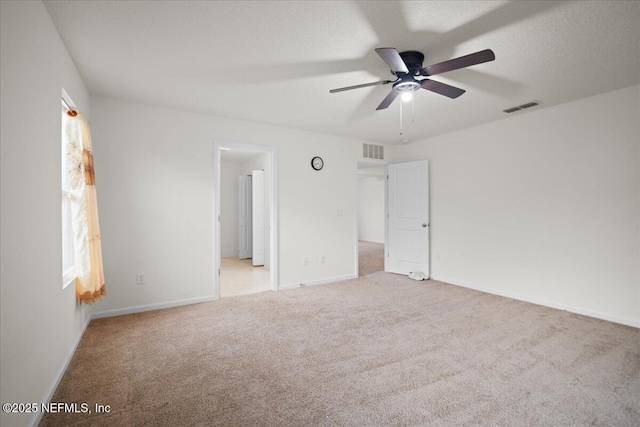 unfurnished bedroom featuring a textured ceiling, carpet flooring, visible vents, and baseboards