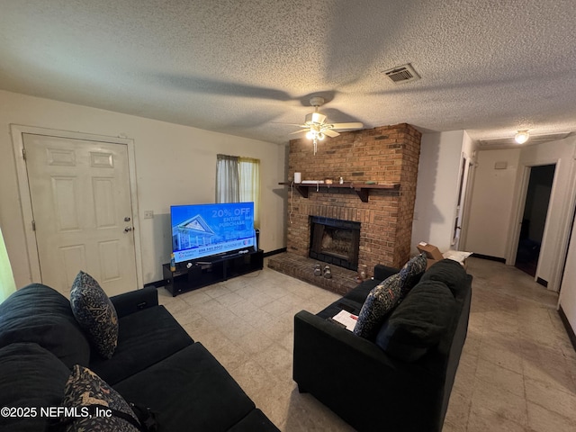 living room featuring baseboards, visible vents, ceiling fan, a textured ceiling, and a fireplace