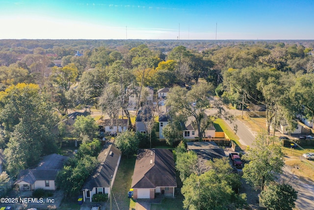 drone / aerial view with a residential view and a view of trees