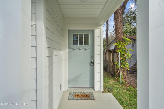 doorway to property with fence