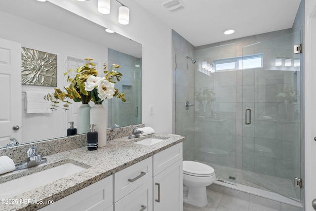 full bathroom with toilet, a shower stall, visible vents, and a sink