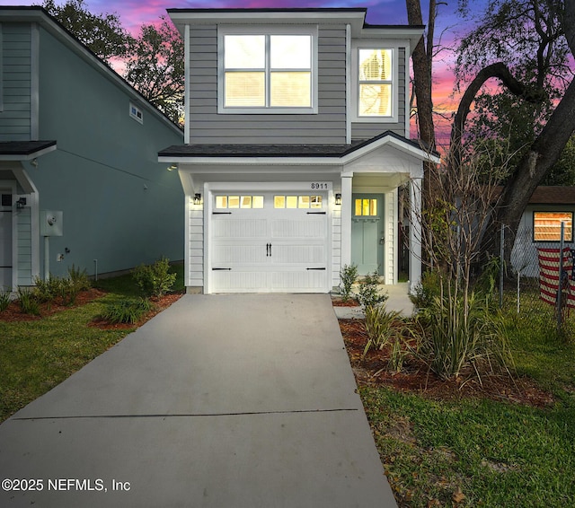 view of front of property with a garage and driveway