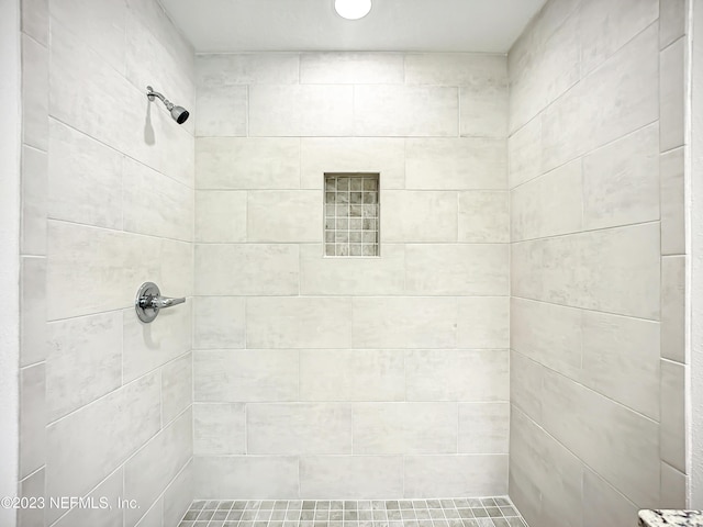 bathroom with a tile shower