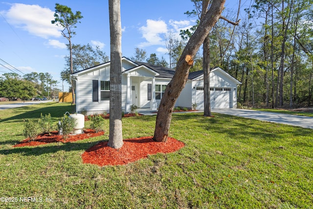 view of front facade with concrete driveway and a front yard